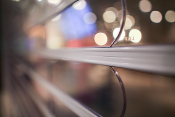 Shallow depth of view shot of transparent roller shutter with bokeh light in background 