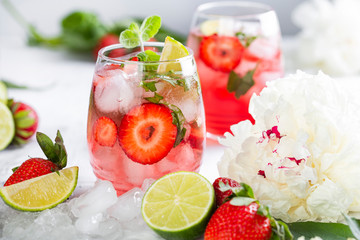 Pink lemonade with strawberries, lime, basil and mint