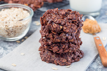 Flourless no bake peanut butter and oatmeal chocolate cookies  with glass of milk, horizontal