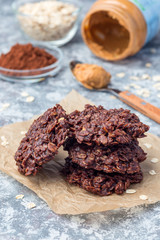 Flourless no bake peanut butter and oatmeal chocolate cookies on parchment, vertical