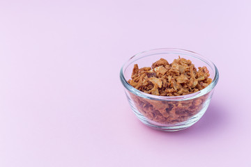 Fried onion in the glass, topping for hot dog, fast food, horizontal on  pink background, copy space