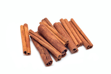 Heap of cinnamon sticks isolated on  white