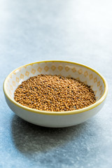 Yellow Mustard Seeds in Small Porcelain Bowl.