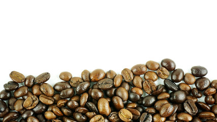 Many coffee beans on a white background with copy space for your text.