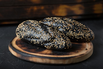 bread,sesame,bakery,homemade,pastry dough,wood - material,soft,freshness,loaf of bread,black color,bun - bread,long loaf