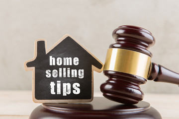 Real estate concept auction gavel and little house with inscription Home selling tips