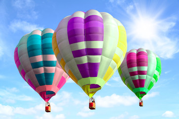 Fototapeta premium Colorful hot air balloon over bright sky with clouds.