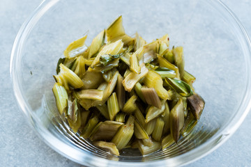 Marinated Chard Root Pickles Cut Diagonal  in Glass Bowl.