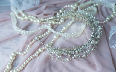 Wedding background with pearls and hair accessories on pink background
