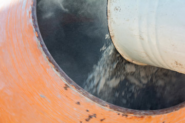 builder working with shovel during concrete cement solution mortar preparation. construction worker...