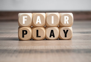 Cubes and dice with the word fair play on wooden background - obrazy, fototapety, plakaty
