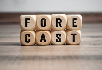 Cubes and dice with term forecast on wooden background