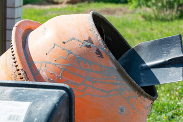 builder working with shovel during concrete cement solution mortar preparation. construction worker...