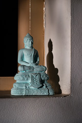 the buddha statue with shadow