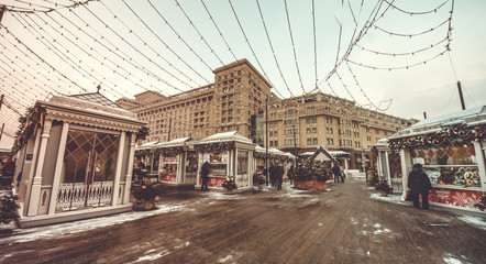 Obraz premium Christmas stalls in the square and Christmas tree. Outdoor vintage colorful carousel in the the city. 10.01.2019 Moscow, Russia