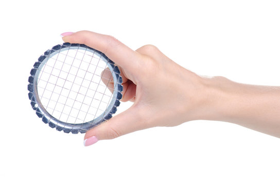 Metal grid vegetable cutter in hand on white background isolation