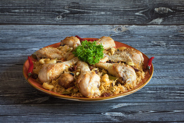 Chicken Arabic Kabsa on a dark wooden background.
