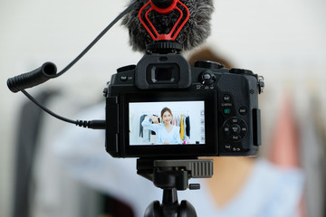 Young asian woman beauty blogger showing cosmetic while recording how to make up video tutorial by camera, vlog concept, beauty and fashion people and technology communication