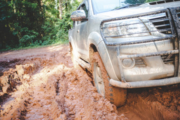  Dirty offroad car, SUV covered with mud on countryside road, Off-road tires,  offroad travel  and...