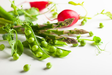 Fresh green  peas pods, radish and green asparagus