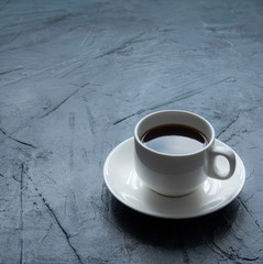 fresh espresso on white cup gray concrete background morning light