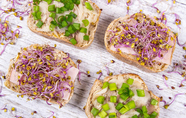 Sandwiches with ham, smoked mackerel and kale sprouts as an ingredient of a healthy diet.