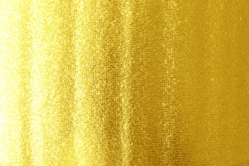 Gold foil with golden sparks for background close up.