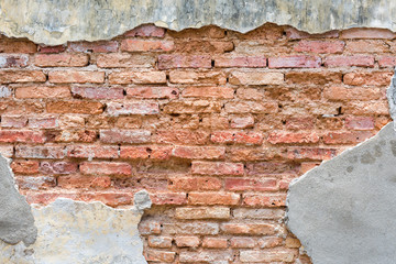 Old red bricklaying wall under cracked cement
