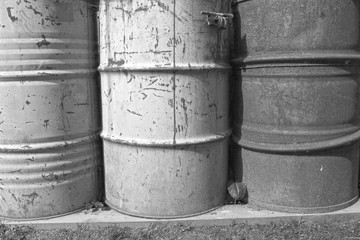 Fototapeta premium Monochrome image of old rusty barrels.