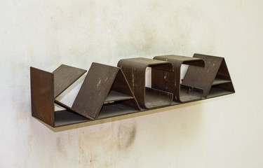 Brown rusty sign on the cashier on the background of bright walls. Cash on the wall.