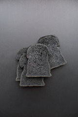 Organic bio charcoal bread on black background
