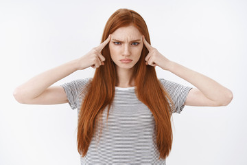 Time concentrate. Serious-looking determined self-centered attractive young redhead girl blue eyes...