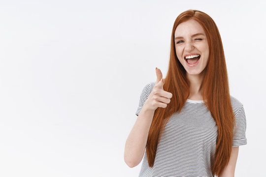 Cheeky good-looking redhead woman straight ginger hair sassy wink camera show thumb up gesture encourage girlfriend great decision, like awesome outfit, agree, approve cool plan, white background
