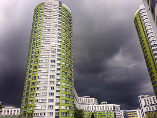 High-rise residential complex on a background of dark sky with thunderclouds