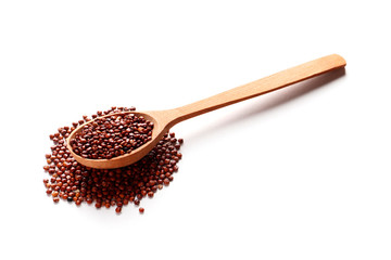 Brown quinoa in a wooden spoon isolated on white background