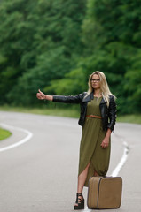 Portrait of a lady standing by the road.