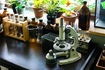 Wooden table vintage chemical laboratory with old Microscope