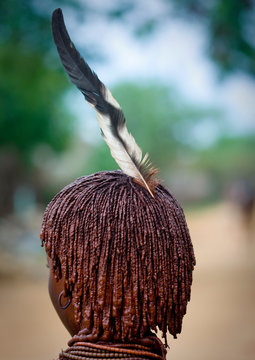 Rear view of hamar tribe woman, With traditional hairstyle and feather, Turmi, Omo valley, Ethiopia