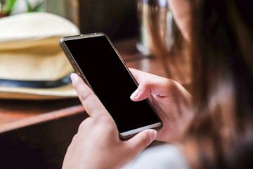 Women use smartphone on hand in cafe