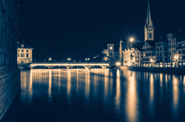 Night view of historic Zurich city center with famous Fraumunster Church