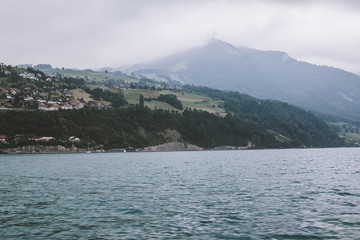View on lake Thun and mountains from ship in city Spiez, Switzerland