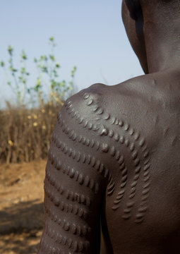 Topossa man with scarifications on his body, Kangate, Omo valley, Ethiopia
