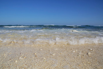 View from a beautiful white sandy beach on the ocean horizon and blue sky