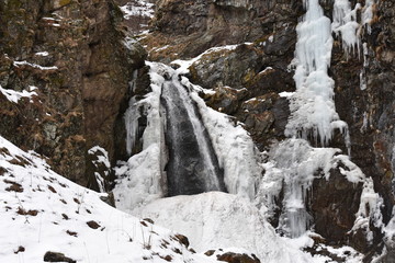 Fototapeta na wymiar Gveleti Small Waterfall in Winter Landscape, Georgia