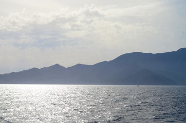 the setting sun in the clouds over the Aegean Sea