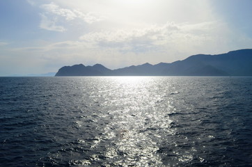 the setting sun in the clouds over the Aegean Sea