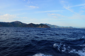 Naklejka premium the setting sun in the clouds over the Aegean Sea