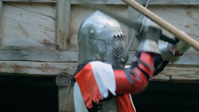 Two militant medieval knights fighting at historical festival. Fantasy, history, reenactment and medieval culture concept