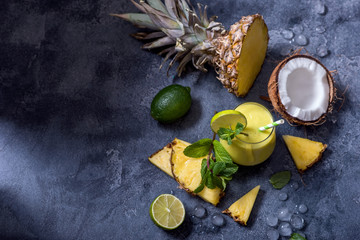 Fototapeta na wymiar Pineapple and coconut tropical cocktail or smoothie, tropical fruit refreshing summer drink