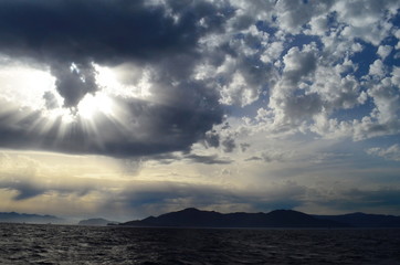 Obraz premium the setting sun in the clouds over the Aegean Sea